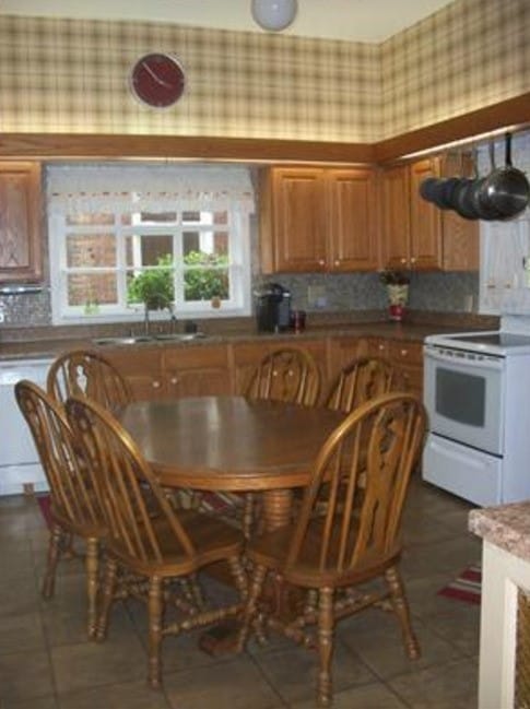 kitchen featuring white appliances, dark tile patterned floors, and sink