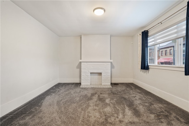 unfurnished living room with dark carpet