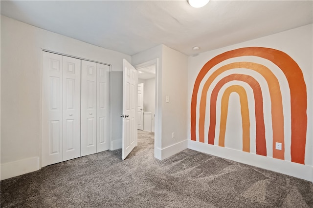 unfurnished bedroom with dark colored carpet