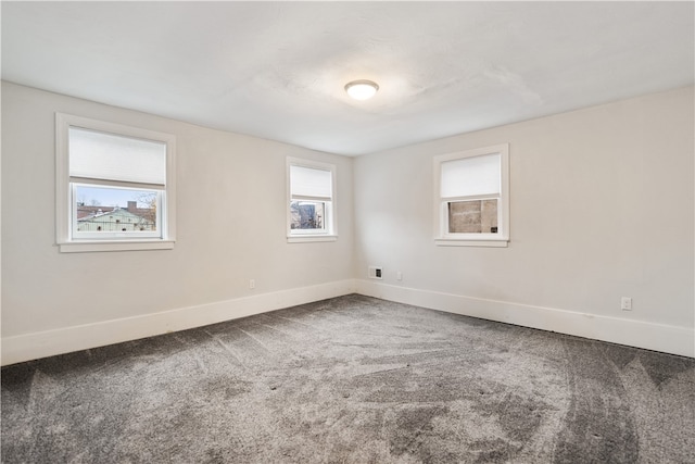 carpeted empty room featuring plenty of natural light