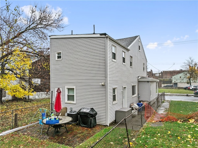 rear view of property with cooling unit