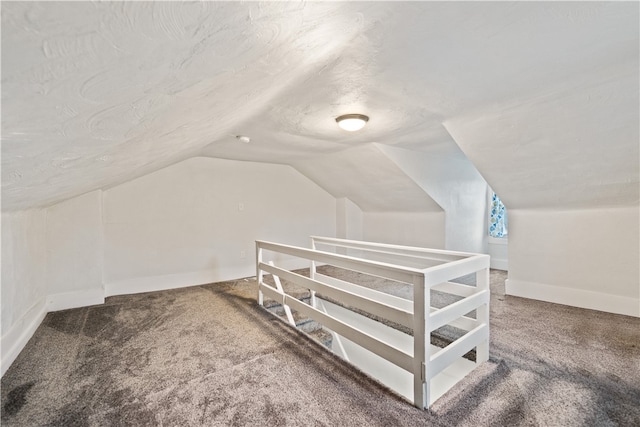 additional living space with carpet flooring and lofted ceiling