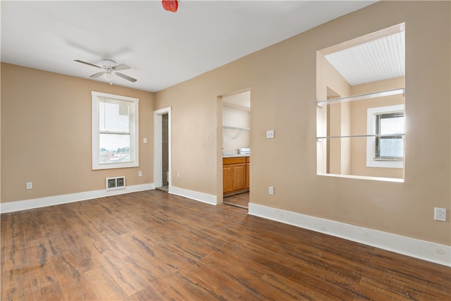 spare room with ceiling fan and dark wood-type flooring