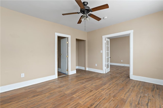 unfurnished room with ceiling fan, french doors, and dark hardwood / wood-style floors