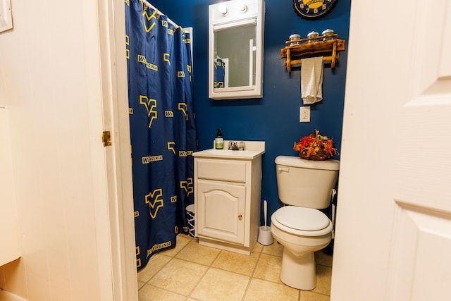 bathroom featuring toilet, vanity, tile patterned floors, and a shower with shower curtain