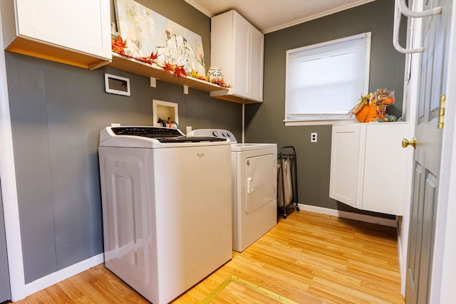 laundry area with independent washer and dryer, cabinets, light wood-type flooring, and ornamental molding