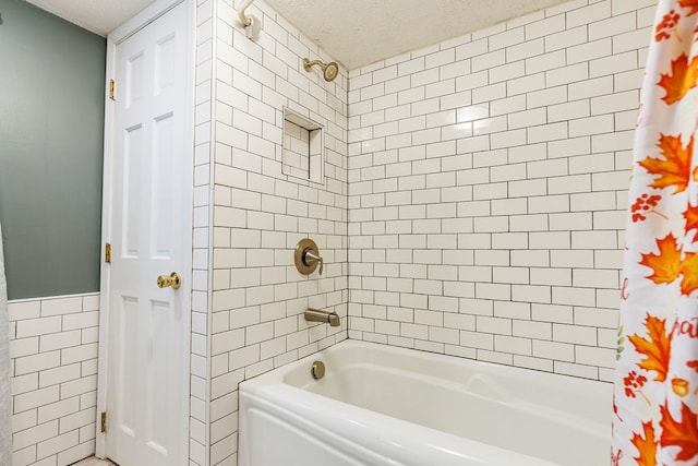 bathroom featuring tile walls, shower / bath combo with shower curtain, and a textured ceiling