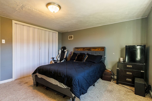 bedroom with a textured ceiling and light colored carpet