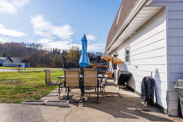 view of patio with a trampoline and area for grilling