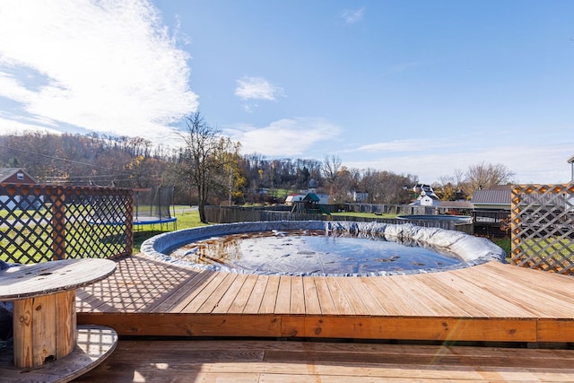 wooden deck with a trampoline