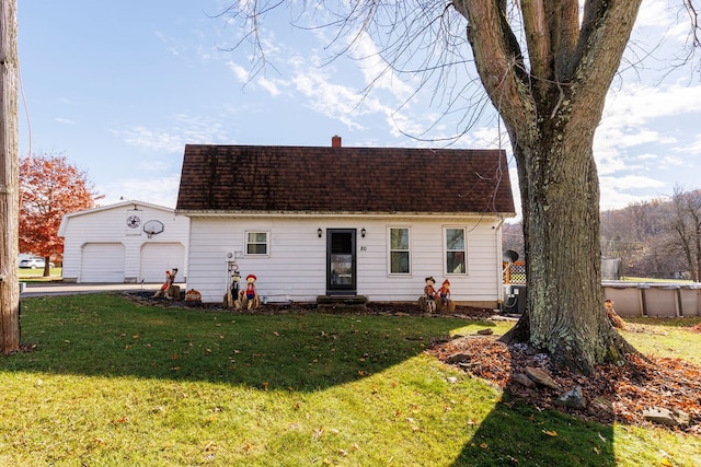 view of front of home with a garage and a front lawn