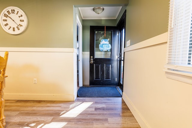 entryway with crown molding and hardwood / wood-style flooring