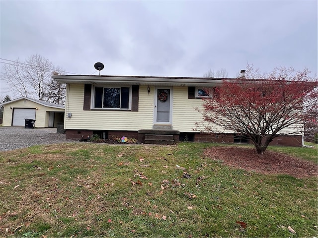 view of front of house with a garage, an outbuilding, and a front lawn