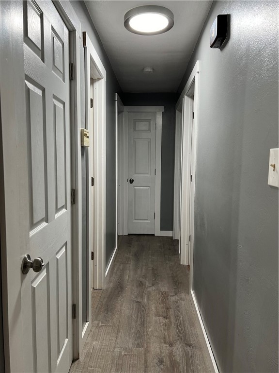 corridor with dark hardwood / wood-style floors