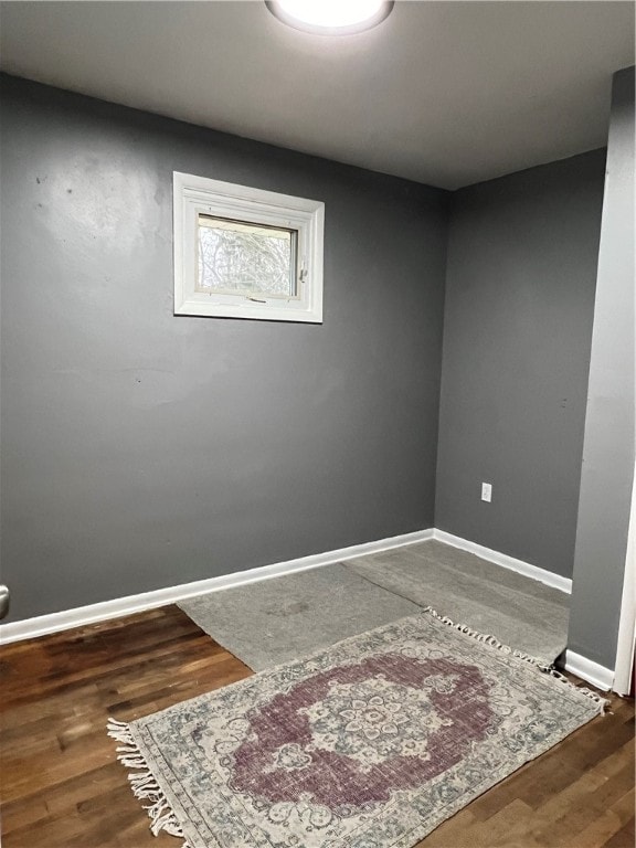 unfurnished room with dark hardwood / wood-style floors