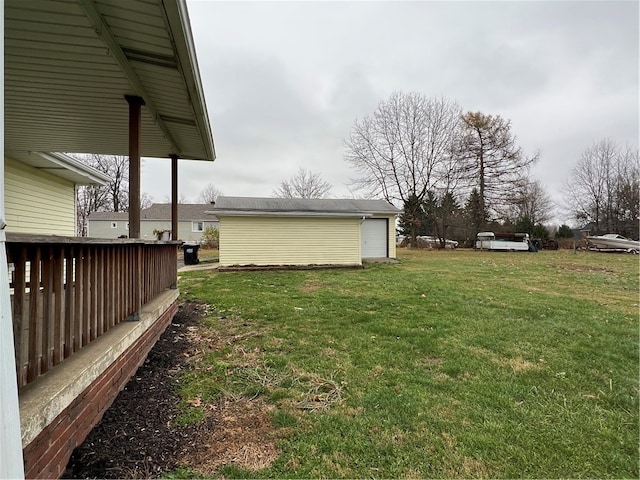 view of yard with a garage, an outdoor structure, and a deck