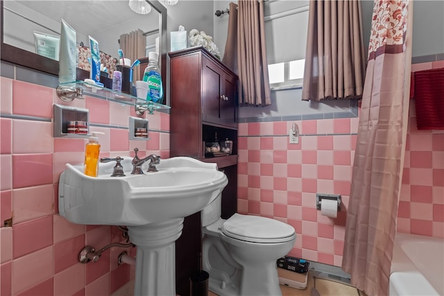 bathroom featuring shower / bath combination with curtain, toilet, and tile walls