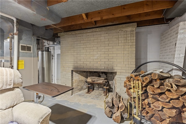 basement featuring water heater and a brick fireplace