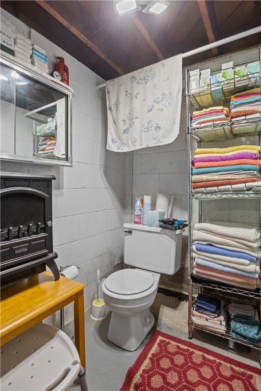 bathroom with concrete floors and toilet