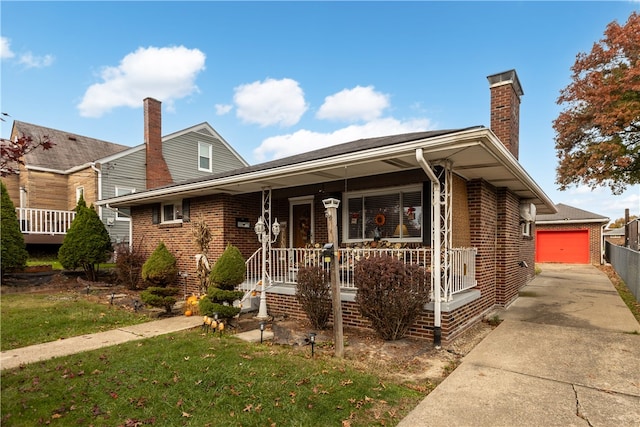 view of front of property featuring an outbuilding, a porch, a garage, and a front yard