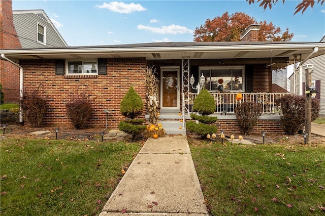 view of front facade featuring covered porch and a front yard