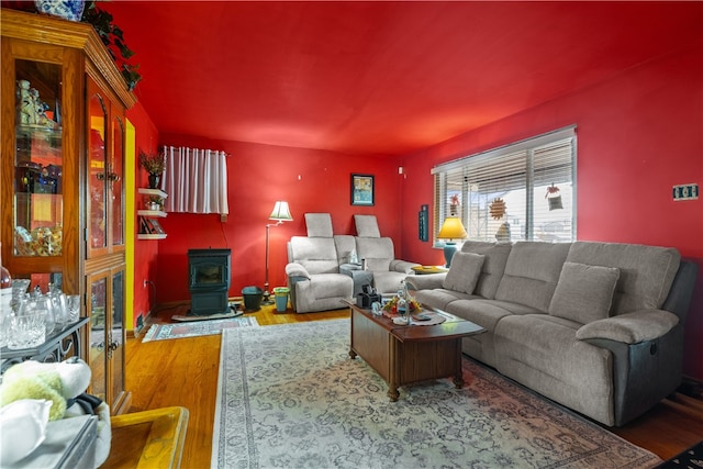 living room featuring a wood stove and hardwood / wood-style floors