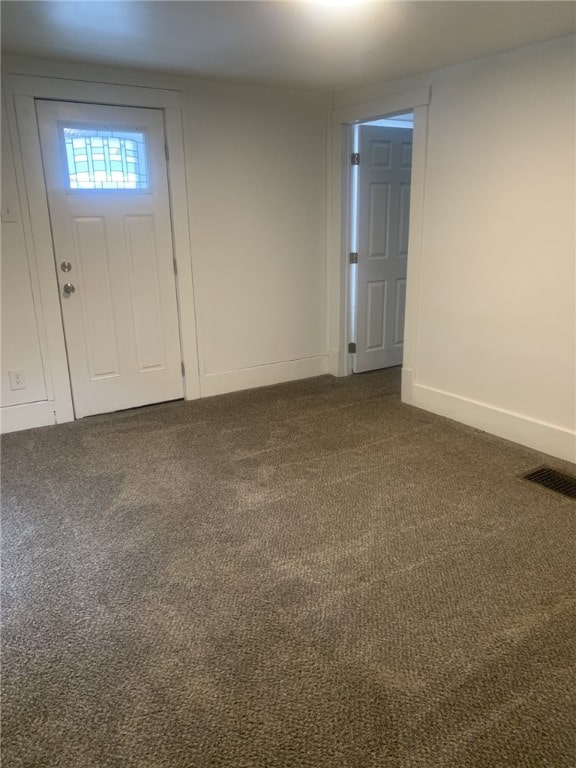 entryway with dark colored carpet