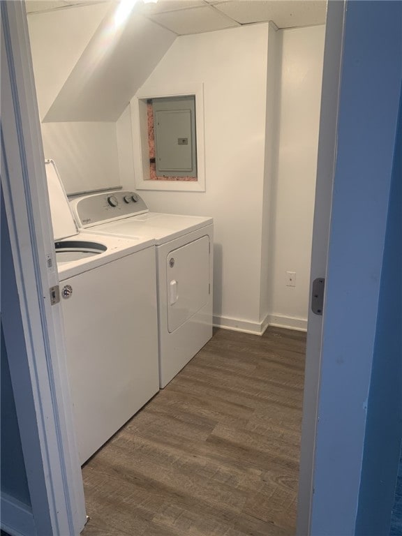 washroom featuring washing machine and clothes dryer, dark hardwood / wood-style flooring, and electric panel