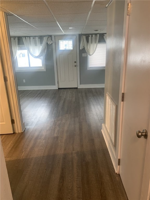 foyer featuring a drop ceiling and dark hardwood / wood-style flooring