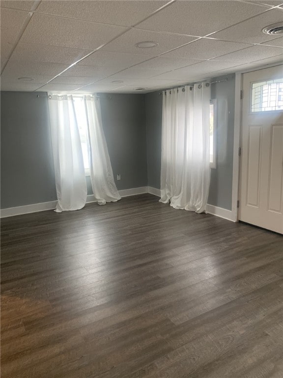 interior space featuring dark wood-type flooring and a paneled ceiling