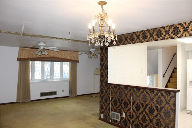 dining area featuring ceiling fan with notable chandelier