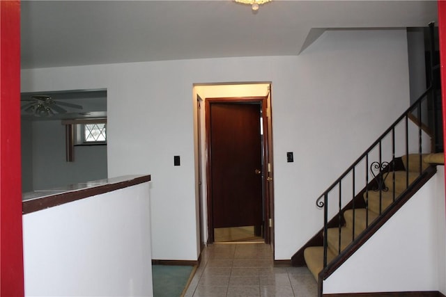 hall with dark tile patterned flooring