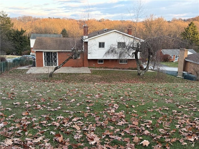 back of property featuring a yard and a patio