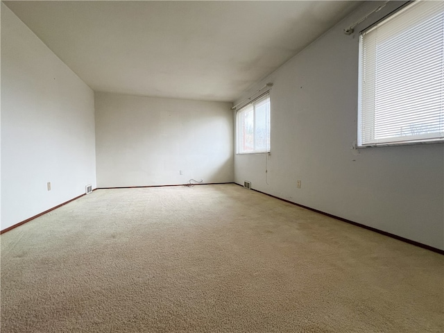 spare room with light carpet