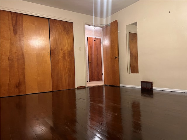 empty room featuring dark wood-type flooring