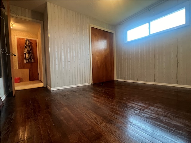 spare room with dark hardwood / wood-style flooring