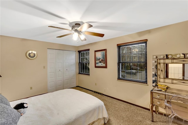 carpeted bedroom with a closet and ceiling fan