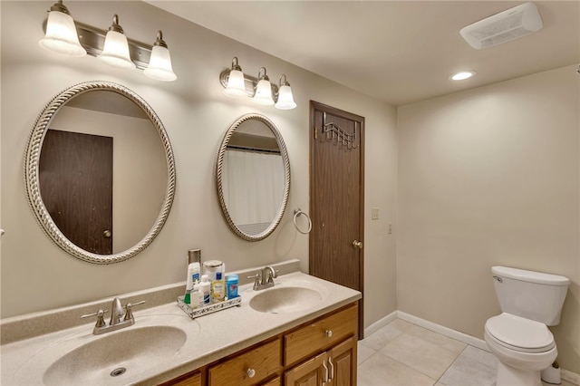 bathroom featuring toilet, vanity, and tile patterned floors