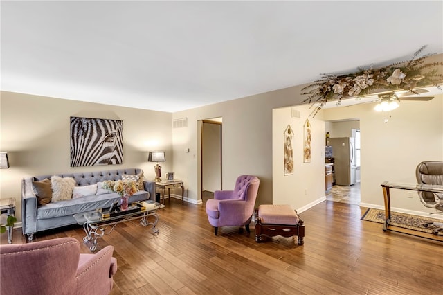 living room featuring ceiling fan and wood-type flooring