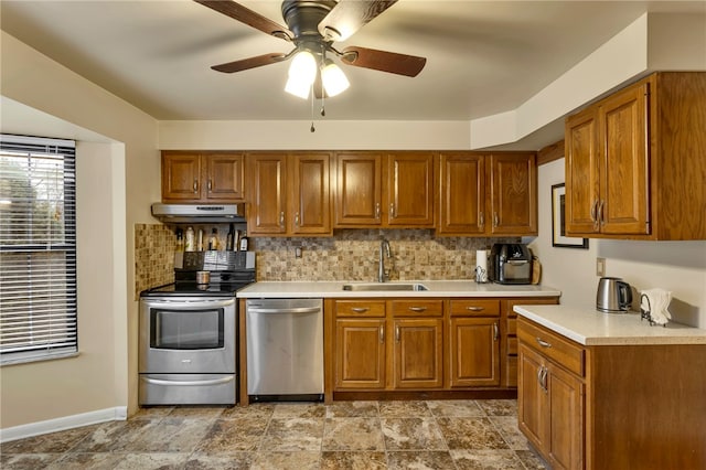 kitchen featuring backsplash, ceiling fan, sink, and stainless steel appliances