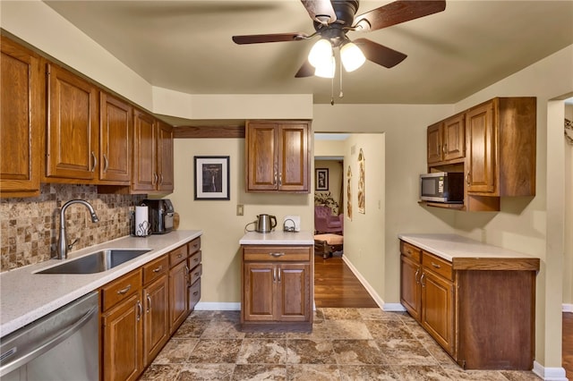 kitchen featuring backsplash, stainless steel appliances, ceiling fan, and sink