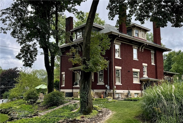 view of side of home featuring a yard