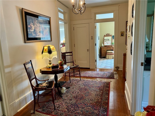 foyer featuring dark wood-type flooring and a notable chandelier