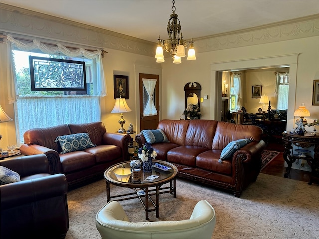 living room featuring hardwood / wood-style floors, crown molding, and a notable chandelier