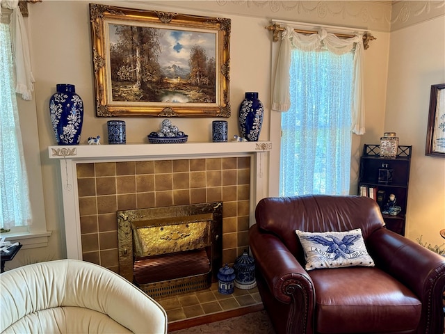 sitting room with plenty of natural light and a tiled fireplace