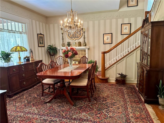 dining room featuring hardwood / wood-style flooring, ornamental molding, and a chandelier