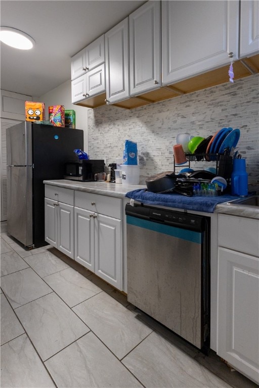 kitchen featuring tasteful backsplash, white cabinetry, and stainless steel appliances