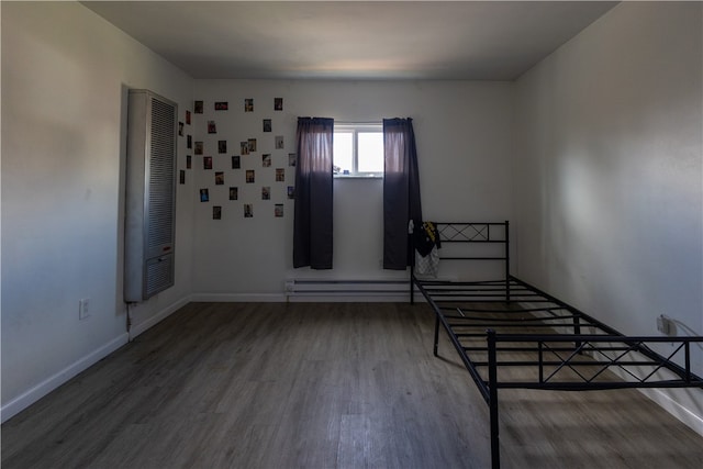 unfurnished bedroom with dark wood-type flooring