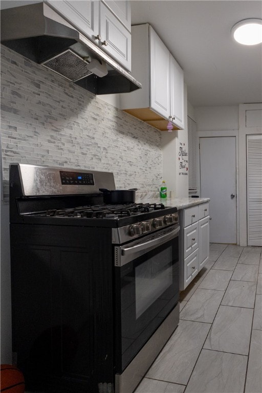 kitchen featuring backsplash, white cabinetry, and stainless steel gas range