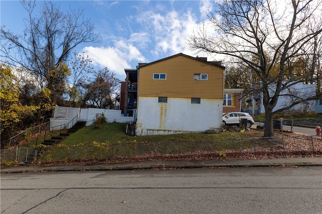 view of side of home with a yard